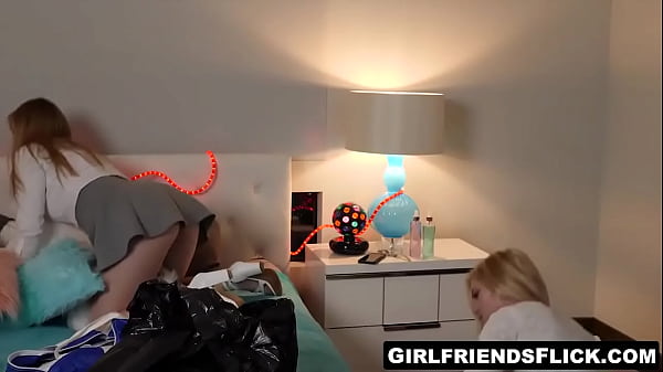 Instead of packing, two slutty girls took their clothes off and fucked on a bed as horny girlfriends.