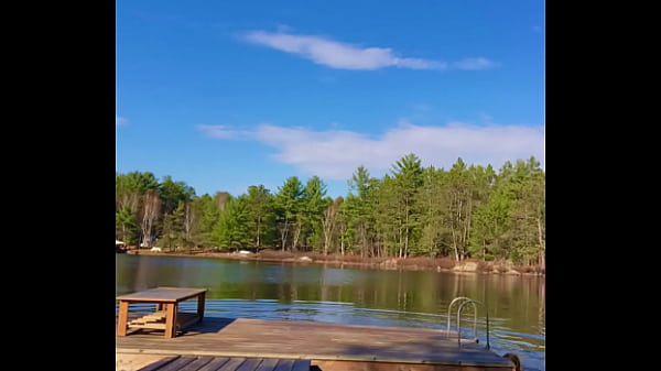 Petite Blonde jumps off a dock into a lake completely naked