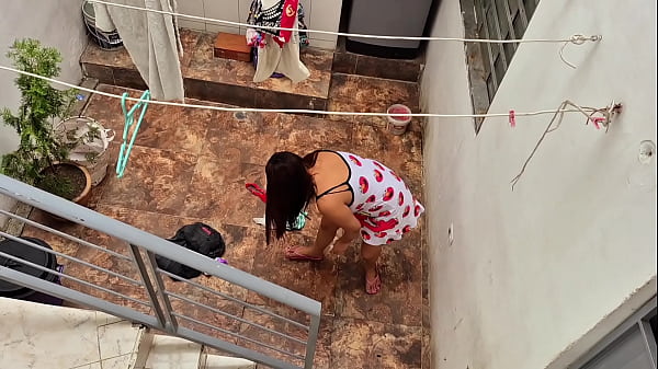 The neighbor is watched washing clothes by her neighbor